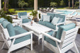 Outdoor patio furniture set with blue cushions by a poolside.